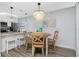 Bright dining area features a charming round table, wood floors and a unique chandelier at 2375 N Beach Rd # 2B, Englewood, FL 34223
