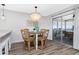 Cozy dining area with a round table, stylish chandelier and sliding door at 2375 N Beach Rd # 2B, Englewood, FL 34223