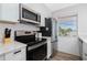 Well-equipped kitchen featuring stainless steel appliances and stone countertops at 2375 N Beach Rd # 2B, Englewood, FL 34223