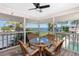 Relaxing lanai with outdoor seating and serene views of the water and lush greenery at 2375 N Beach Rd # 2B, Englewood, FL 34223