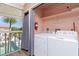 Convenient laundry room offers a view of the outdoors, washer and dryer at 2375 N Beach Rd # 2B, Englewood, FL 34223