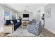 Bright living room featuring stylish decor, a comfortable sofa, and natural light pouring in from the windows at 2375 N Beach Rd # 2B, Englewood, FL 34223