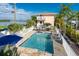 Aerial view of a refreshing pool with palm trees and a beautiful building in the background at 2375 N Beach Rd # 2B, Englewood, FL 34223