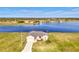 Beautiful lakefront home with manicured lawn, long driveway, and well-maintained exterior at 43 Blue Hen Dr, Placida, FL 33946