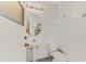 Bathroom with toilet, small sink, and tiled walls at 43 Blue Hen Dr, Placida, FL 33946
