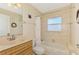 Bathroom featuring a tub with shower, a sink, toilet, and light fixtures at 43 Blue Hen Dr, Placida, FL 33946