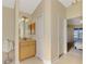 Spacious bathroom with wood vanity, plenty of storage, and access to an adjacent bedroom at 43 Blue Hen Dr, Placida, FL 33946