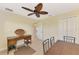 Bedroom with a desk, ceiling fan, and view into another room at 43 Blue Hen Dr, Placida, FL 33946