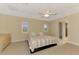 Bedroom with neutral colored walls, carpet flooring, ceiling fan and a backyard view at 43 Blue Hen Dr, Placida, FL 33946