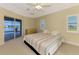 Bright bedroom boasting carpet flooring, ceiling fan, backyard views, and access to pool at 43 Blue Hen Dr, Placida, FL 33946