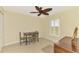 Cozy bedroom with a ceiling fan, shutters, and a small dining table set at 43 Blue Hen Dr, Placida, FL 33946