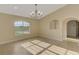 Bright living room features tiled floors, a chandelier, and a large window providing natural light at 43 Blue Hen Dr, Placida, FL 33946