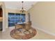 Bright dining room features a chandelier, and views of the water and pool through the sliding door at 43 Blue Hen Dr, Placida, FL 33946