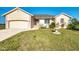Home exterior showcasing the well-maintained lawn, garage, and water fountain at 43 Blue Hen Dr, Placida, FL 33946