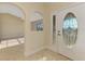 Inviting foyer features arched doorways and a decorative glass front door, creating a grand entrance at 43 Blue Hen Dr, Placida, FL 33946