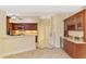 Open kitchen with wooden cabinetry, stainless steel microwave, and complementary backsplash at 43 Blue Hen Dr, Placida, FL 33946
