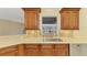 Kitchen sink featuring neutral countertops, wooden cabinetry, and backyard view at 43 Blue Hen Dr, Placida, FL 33946