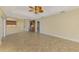 Open concept living room featuring tile flooring, ceiling fan, and direct access to the kitchen at 43 Blue Hen Dr, Placida, FL 33946