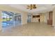 Bright living room boasting tile flooring, ceiling fan, and large glass doors to pool at 43 Blue Hen Dr, Placida, FL 33946