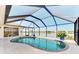 Relaxing enclosed pool with a beautiful lake view and tropical plants at 43 Blue Hen Dr, Placida, FL 33946
