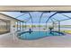 Screened-in pool with a view of a lake at 43 Blue Hen Dr, Placida, FL 33946