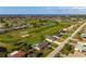 Stunning aerial view of a home with a private pool, near a golf course and landscaped community at 84 Caddy Rd, Rotonda West, FL 33947