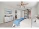 Relaxing primary bedroom with a ceiling fan, soft carpet, and a sliding barn door to the ensuite bathroom at 84 Caddy Rd, Rotonda West, FL 33947
