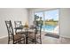 The dining area has sliding glass doors that offer picturesque views of the sparkling pool outside at 84 Caddy Rd, Rotonda West, FL 33947