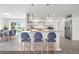 Bright kitchen features modern stainless steel appliances, bar seating, and an open floor plan at 84 Caddy Rd, Rotonda West, FL 33947