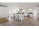 Open floor plan showcases kitchen island, modern stainless appliances, and expansive living space at 84 Caddy Rd, Rotonda West, FL 33947
