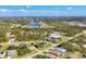 Aerial view of houses with a lake in the background, and lots of green space at 100 Hobo Rd, Rotonda West, FL 33947