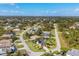 An aerial view of the neighborhood shows well-maintained homes and manicured lawns at 100 Hobo Rd, Rotonda West, FL 33947