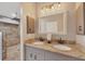 Well-lit bathroom features a double sink vanity with granite counters and walk-in shower at 100 Hobo Rd, Rotonda West, FL 33947