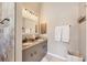 Well-lit bathroom features a double sink vanity with granite counters and neutral decor at 100 Hobo Rd, Rotonda West, FL 33947