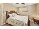 Bedroom features a ceiling fan, wood floors and neutral decor at 100 Hobo Rd, Rotonda West, FL 33947