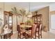 Dining area featuring a glass-top table, upholstered chairs, and decorative shelving, creating an inviting dining experience at 100 Hobo Rd, Rotonda West, FL 33947