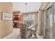 Bright dining area with table, wicker chairs, modern pendant lighting, and adjacent kitchen at 100 Hobo Rd, Rotonda West, FL 33947