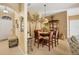Dining area featuring a glass-top table, upholstered chairs, and a decorative mural, creating a welcoming atmosphere at 100 Hobo Rd, Rotonda West, FL 33947