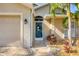 Close-up of the front door, showing beautiful decorative details and well-manicured landscaping, adding to the home's appeal at 100 Hobo Rd, Rotonda West, FL 33947