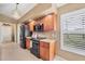 Bright kitchen with wooden cabinets, granite countertops, tile flooring, and stainless steel appliances at 100 Hobo Rd, Rotonda West, FL 33947