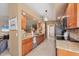 Bright kitchen features wooden cabinets, granite countertops, tiled backsplash, and stainless steel appliances at 100 Hobo Rd, Rotonda West, FL 33947
