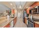 Updated kitchen with wooden cabinetry, granite countertops, stainless appliances, and tile backsplash at 100 Hobo Rd, Rotonda West, FL 33947