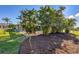 Tropical landscaping surrounds the backyard, with a pool and a well-maintained garden at 100 Hobo Rd, Rotonda West, FL 33947