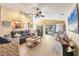 Spacious living room with neutral tones, comfortable seating, and a view of the pool through large sliding glass doors at 100 Hobo Rd, Rotonda West, FL 33947