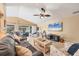 Bright living room with ample seating, a ceiling fan, and a coastal-themed TV, offering a relaxing space to unwind at 100 Hobo Rd, Rotonda West, FL 33947
