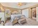 Well-lit main bedroom featuring tile floors, comfortable furnishings, and private ensuite bathroom at 100 Hobo Rd, Rotonda West, FL 33947