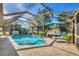 Beautiful in-ground pool with screened enclosure and lush landscaping at 100 Hobo Rd, Rotonda West, FL 33947