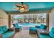 Covered patio features comfortable seating around a pristine screened-in pool at 100 Hobo Rd, Rotonda West, FL 33947