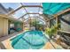 Gorgeous pool area surrounded by a screened enclosure and patio space at 100 Hobo Rd, Rotonda West, FL 33947