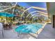Sparkling in-ground pool surrounded by screened enclosure and landscaped yard at 100 Hobo Rd, Rotonda West, FL 33947